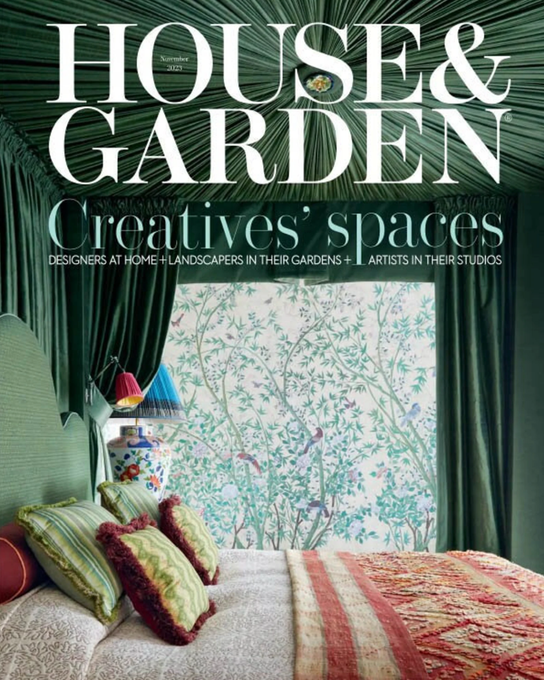 House & Garden magazine cover featuring a richly layered bedroom with patterned textiles, green drapery, and a large window framed by botanical wallpaper.
