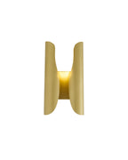 Sebastian wall sconce in brushed brass, featuring a sculptural curved double-panel design that softly diffuses light, shown against a white background.