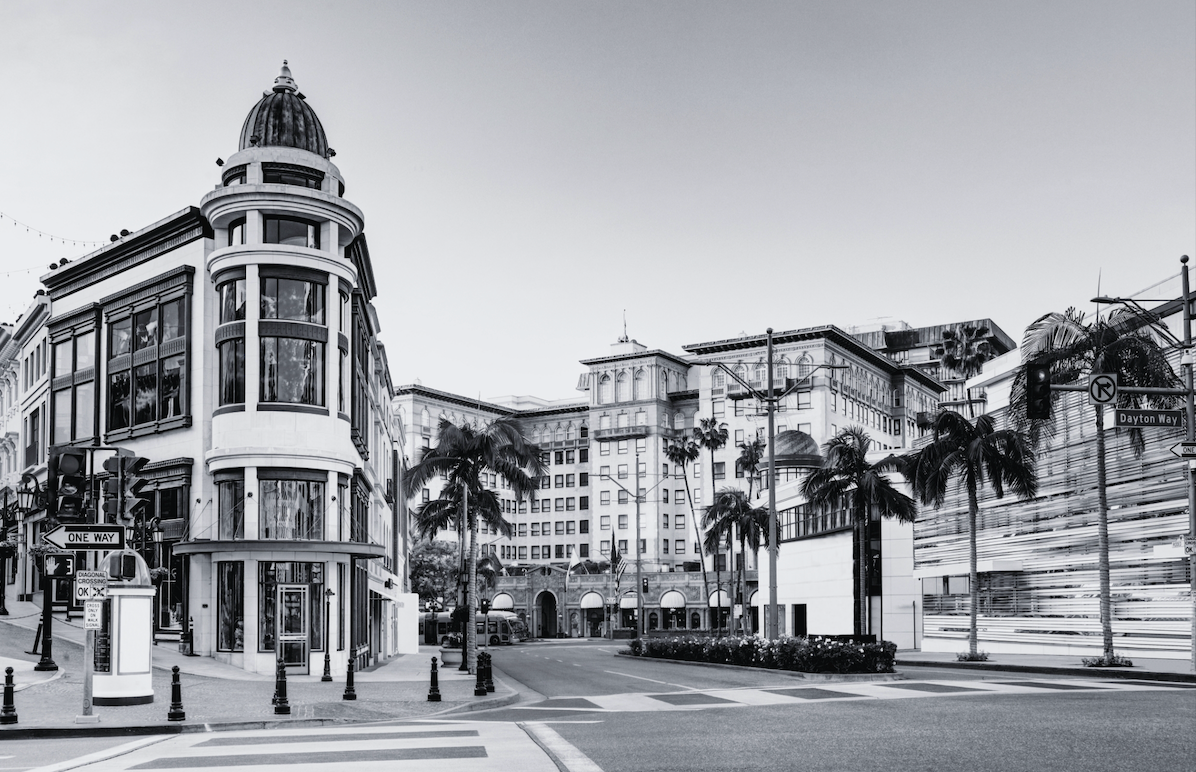 Historic building on a palm-lined street in California.