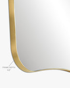 Asymmetrical mirror close-up showing a thin brass-colored metal frame with a labeled 0.8-inch frame depth on a white background.