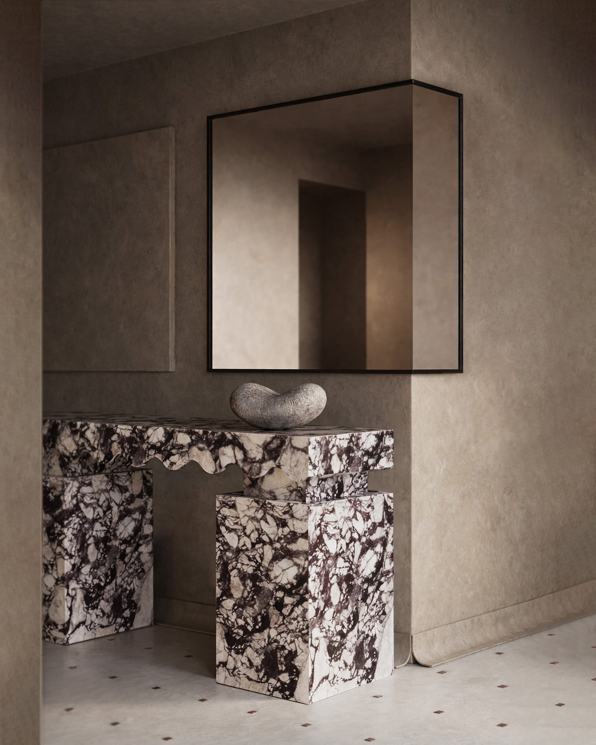 Marble console table with sculpted edges positioned against a wall with a square mirror above.