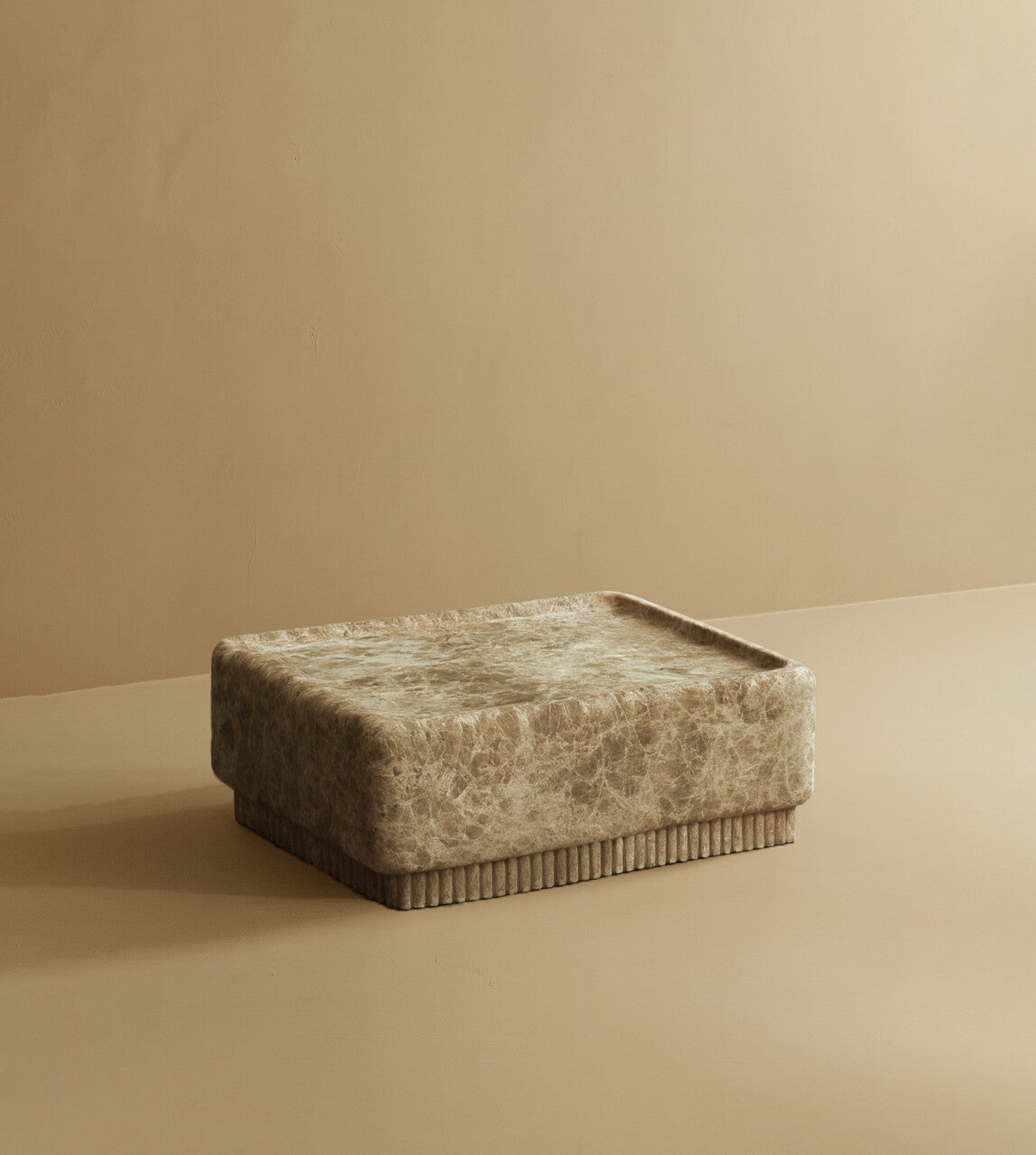 Square coffee table made from Emperador marble with warm brown tones and natural veining, featuring a solid block top and a low, ribbed base.