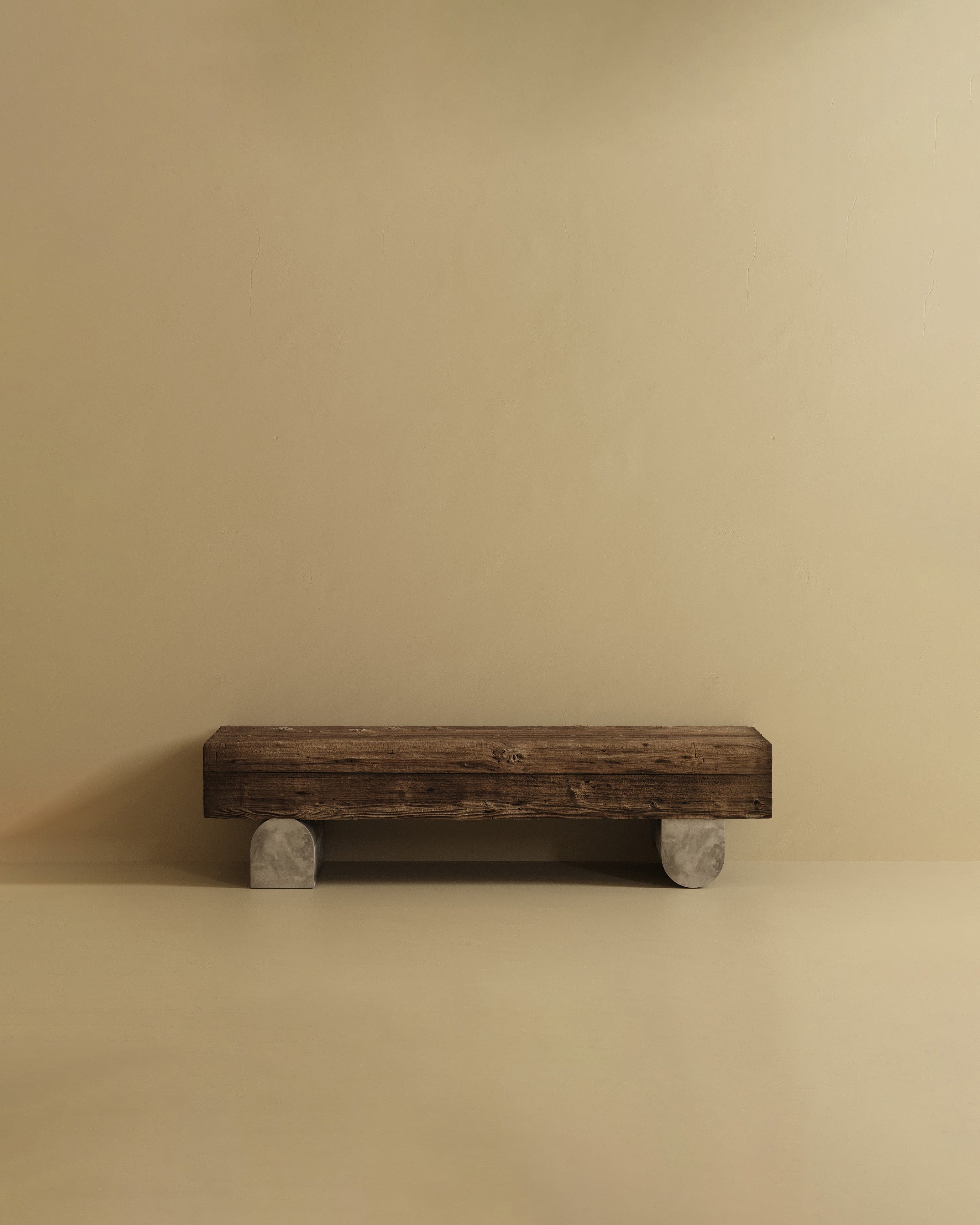Rectangular bench made from solid wood with a natural textured finish, supported by two fiber block legs.