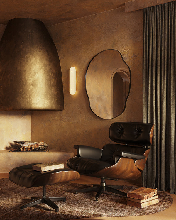 Interior featuring a leather lounge chair with ottoman, a sculptural fireplace, a wall mirror, and floor-length curtains.